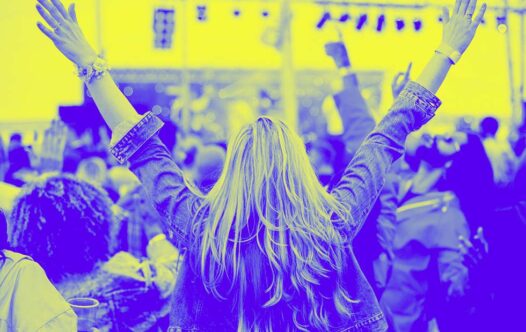A woman cheers in a crowd at an event made possible with a chip and pin machine available for short-term hire.