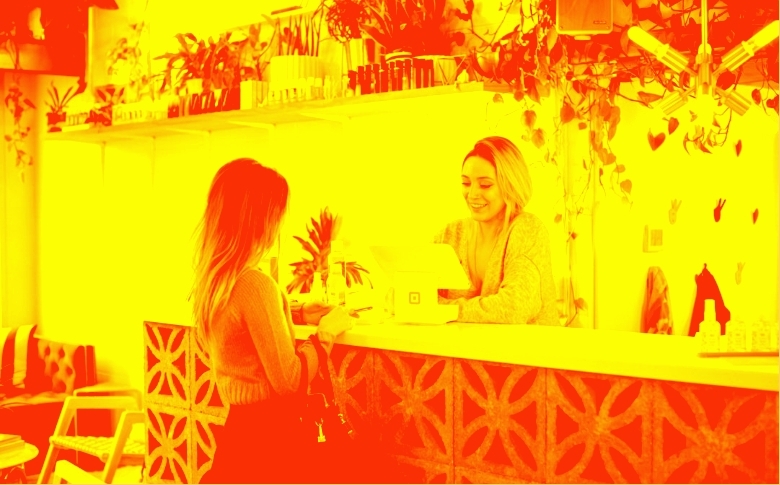 A woman talks to concierge at hotel front desk