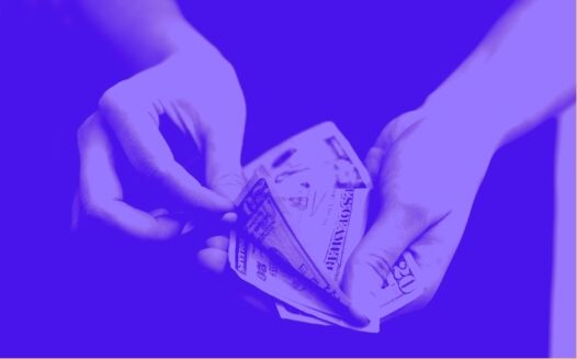 Hands holding bills and peeling one off